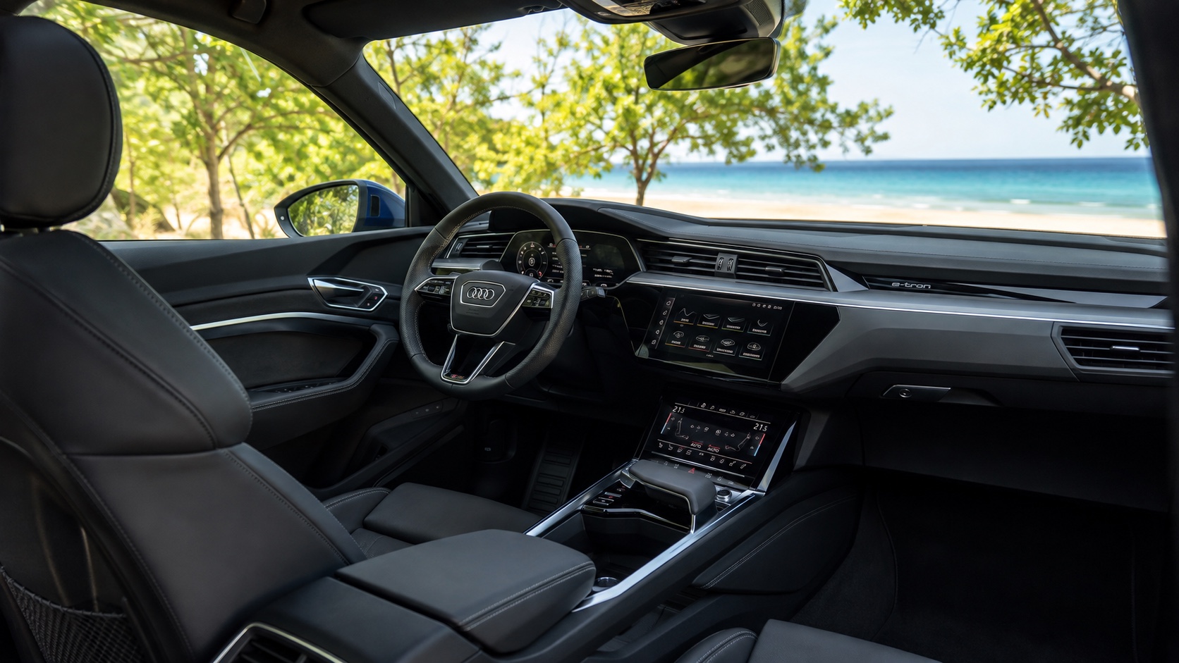 Audi Q8 Sportback e-tron-kabine set skråt fra højre bagsæde med alle fabriksmonterede skærme tændt