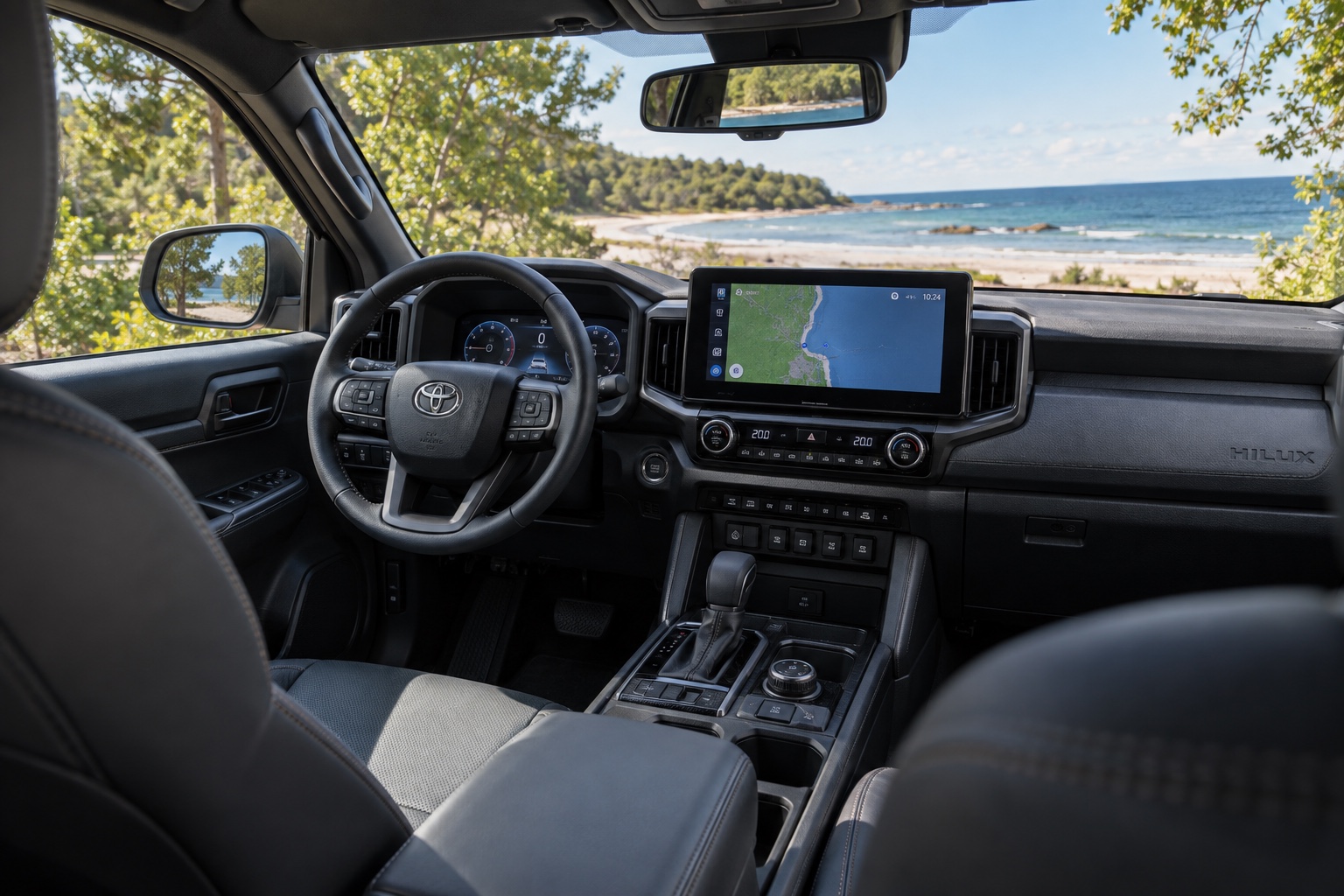 Toyota Hilux Electric 2026 interiør med rat, digital instrumentering og tændt multimedieskærm